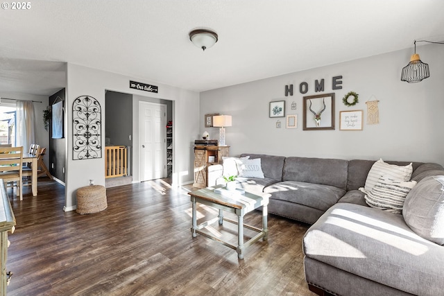living area featuring baseboards and wood finished floors