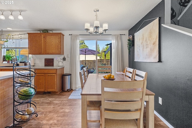 3501 O St, Vancouver, WA 98663 - dining space with a chandelier, healthy amount of natural light, light wood-type flooring, a textured ceiling, and rail lighting