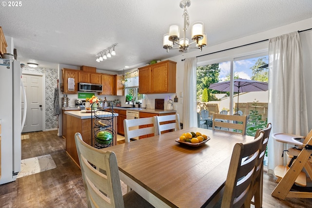 3501 O St, Vancouver, WA 98663 - dining space featuring a chandelier, a textured ceiling, dark wood-type flooring, track lighting, and wallpapered walls