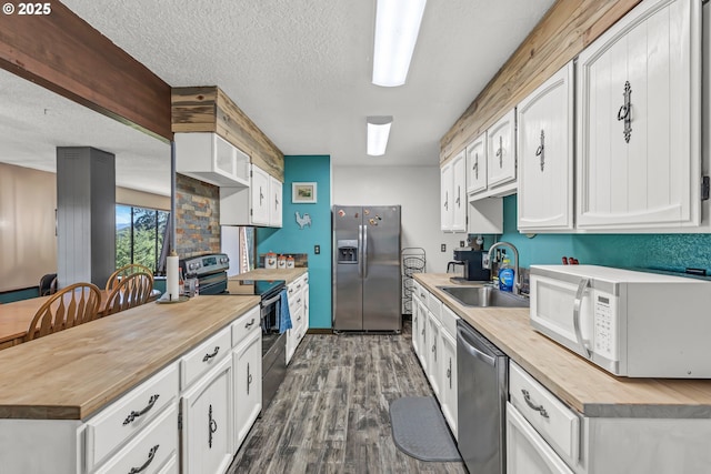 331 Hemlock Ln, Roseburg, OR 97471 - kitchen featuring wood counters, dark wood-style flooring, a sink, and appliances with stainless steel finishes