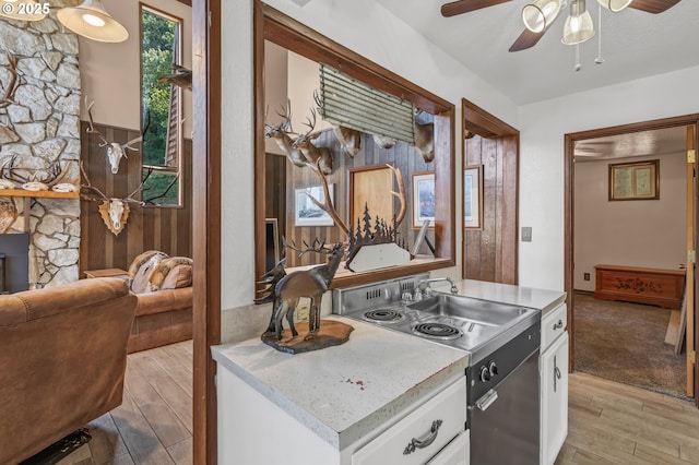 331 Hemlock Ln, Roseburg, OR 97471 - kitchen featuring white cabinetry, light countertops, a ceiling fan, range, and light wood-style floors
