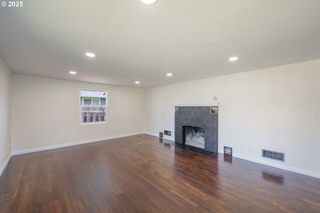 562 Gatch St, Woodburn, OR 97071 - unfurnished living room featuring wood finished floors, recessed lighting, and a tile fireplace