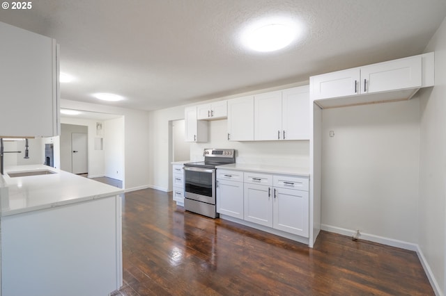 562 Gatch St, Woodburn, OR 97071 - kitchen with stainless steel electric stove, dark wood finished floors, and white cabinetry