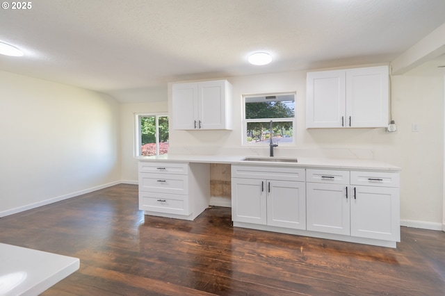 562 Gatch St, Woodburn, OR 97071 - kitchen featuring a sink, white cabinetry, light countertops, dark wood finished floors, and baseboards