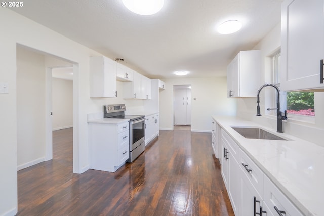 562 Gatch St, Woodburn, OR 97071 - kitchen with stainless steel range with electric cooktop, dark wood-type flooring, white cabinets, and light stone counters