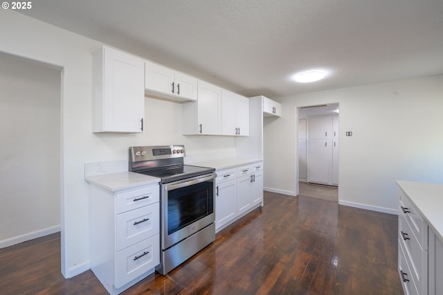562 Gatch St, Woodburn, OR 97071 - kitchen featuring stainless steel electric range, dark wood-type flooring, white cabinets, and light stone countertops