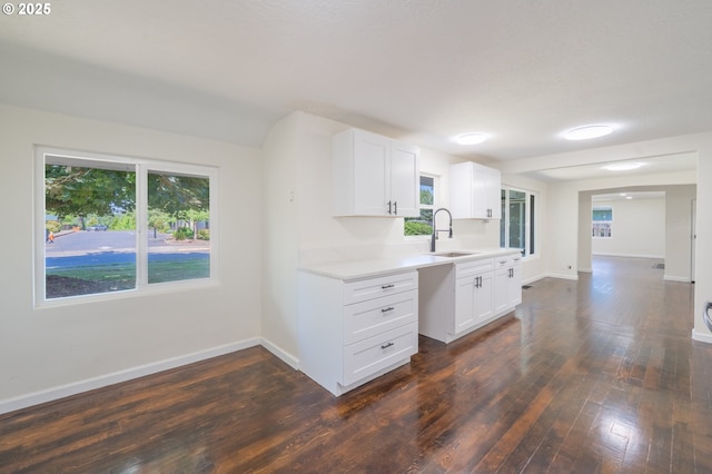 562 Gatch St, Woodburn, OR 97071 - kitchen featuring light countertops, plenty of natural light, dark wood-style floors, and white cabinetry