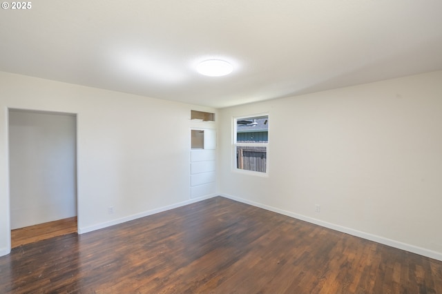 562 Gatch St, Woodburn, OR 97071 - empty room with dark wood finished floors and baseboards