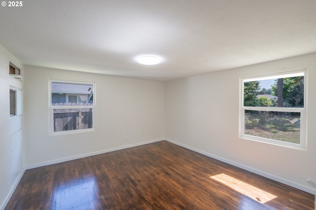 562 Gatch St, Woodburn, OR 97071 - empty room featuring dark wood-style flooring and baseboards