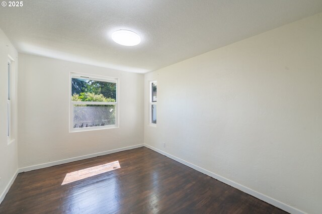 562 Gatch St, Woodburn, OR 97071 - unfurnished room with dark wood finished floors and baseboards