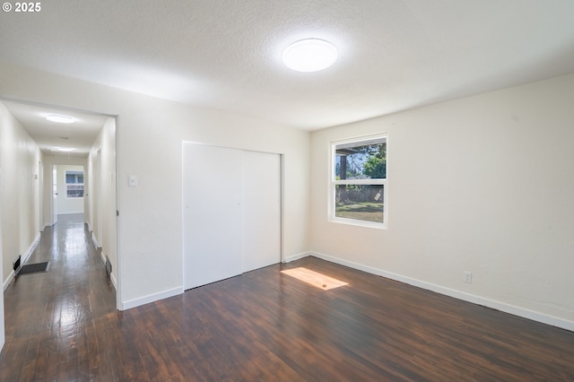 562 Gatch St, Woodburn, OR 97071 - unfurnished bedroom with dark wood finished floors, a closet, and baseboards