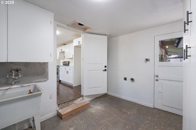 562 Gatch St, Woodburn, OR 97071 - kitchen featuring stainless steel electric range oven, baseboards, white cabinetry, light countertops, and a sink