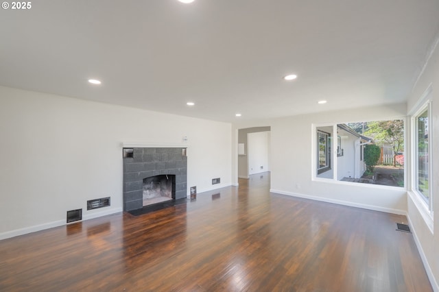 562 Gatch St, Woodburn, OR 97071 - unfurnished living room featuring wood finished floors, a fireplace with flush hearth, recessed lighting, and baseboards