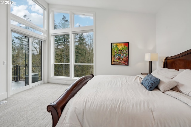 carpeted bedroom featuring access to outside
