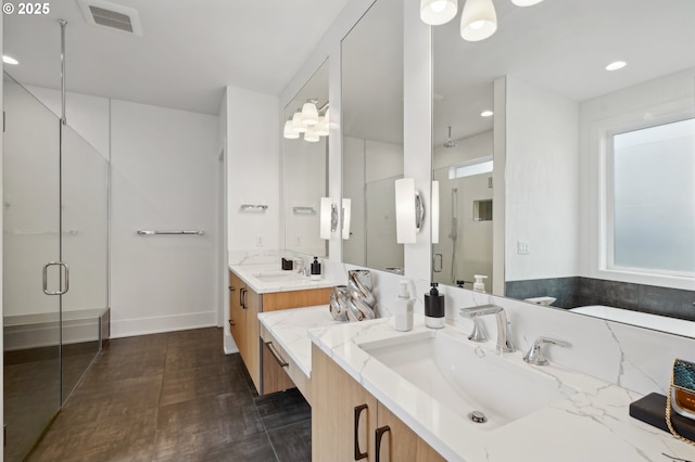 bathroom with a shower stall, vanity, baseboards, and recessed lighting