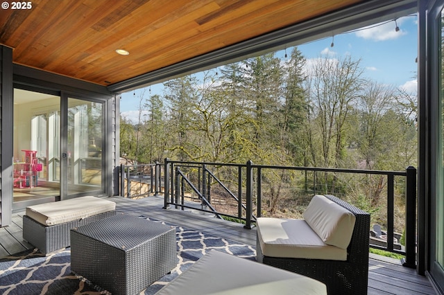 deck featuring view of wooded area