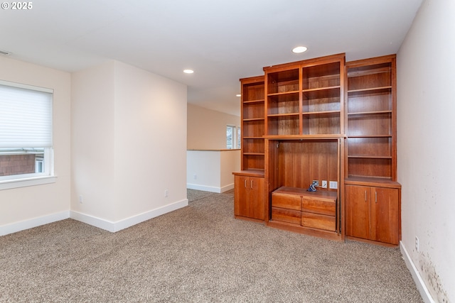 carpeted spare room with visible vents, baseboards, and recessed lighting