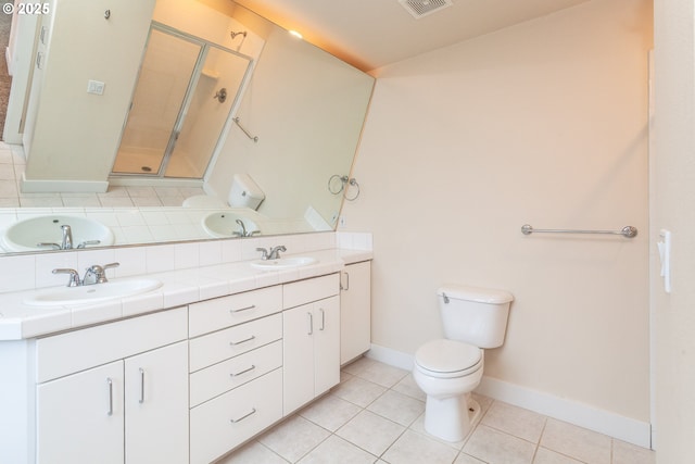 full bathroom with tile patterned flooring, a sink, a shower stall, and toilet