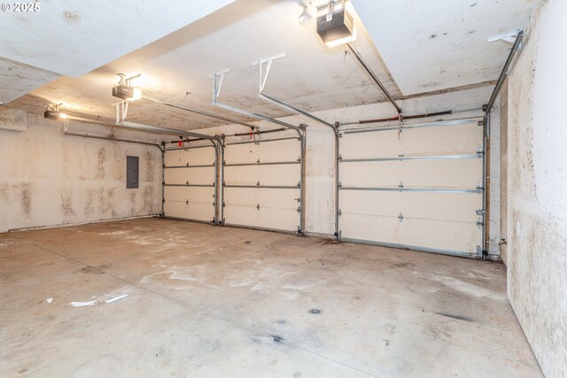 garage featuring electric panel and a garage door opener