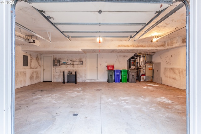 garage with electric panel and a garage door opener