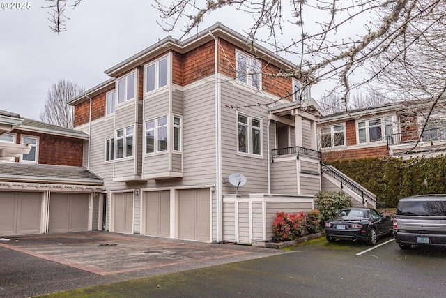 view of front of property with stairway and community garages