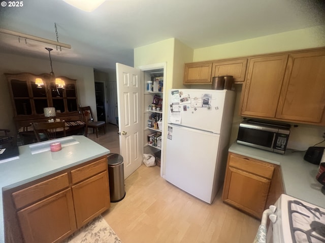4733 Spring Meadow Ave, Eugene, OR 97404 - kitchen featuring white appliances, light wood-style flooring, and light countertops