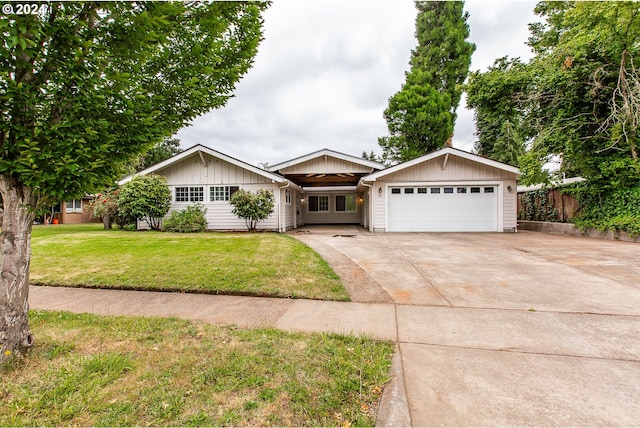127 Roan Dr, Eugene, OR 97401 - ranch-style house with a garage, a front yard, concrete driveway, and board and batten siding