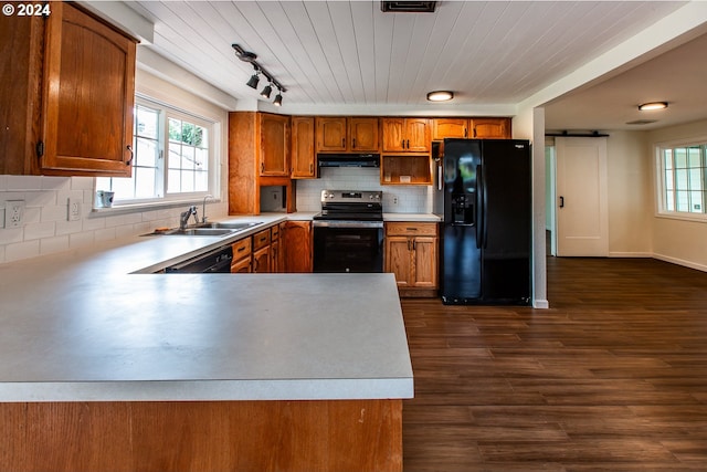 127 Roan Dr, Eugene, OR 97401 - kitchen with electric range, black fridge, a sink, exhaust hood, and brown cabinets