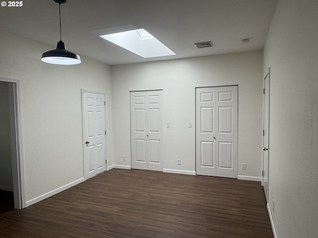 127 Roan Dr, Eugene, OR 97401 - empty room featuring a skylight, dark wood-style floors, baseboards, and a smoke detector