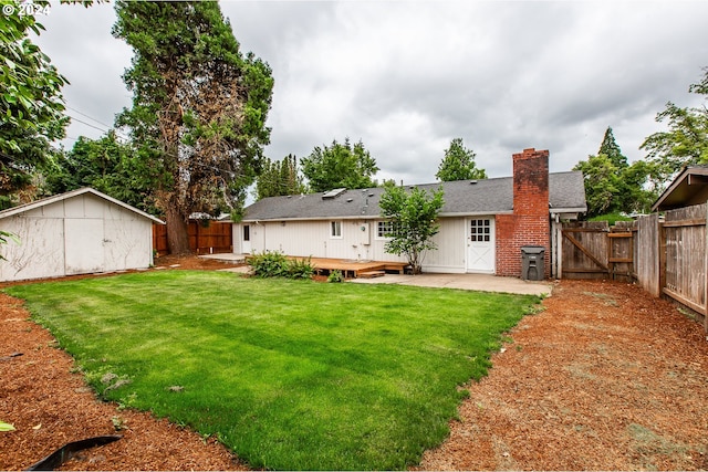 127 Roan Dr, Eugene, OR 97401 - back of house with a chimney, an outdoor structure, a patio, a gate, and roof with shingles