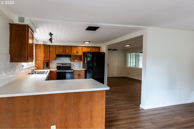 127 Roan Dr, Eugene, OR 97401 - kitchen with electric stove, black fridge, a sink, under cabinet range hood, and brown cabinets