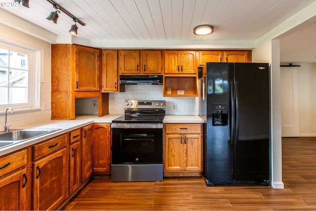 127 Roan Dr, Eugene, OR 97401 - kitchen featuring black fridge with ice dispenser, stainless steel electric range oven, a sink, under cabinet range hood, and brown cabinets
