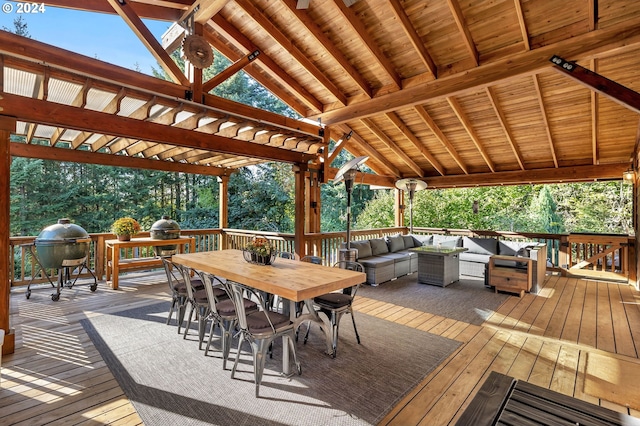 wooden terrace with a grill, outdoor dining area, a pergola, and an outdoor hangout area