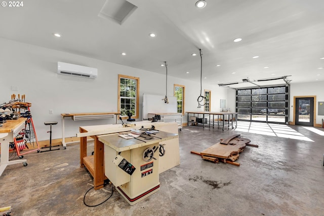 miscellaneous room with a workshop area, concrete floors, and a wall mounted AC