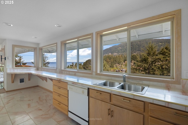 213 University Ave, Manzanita, OR 97130 - kitchen with recessed lighting, marble finish floor, a sink, white dishwasher, and baseboards