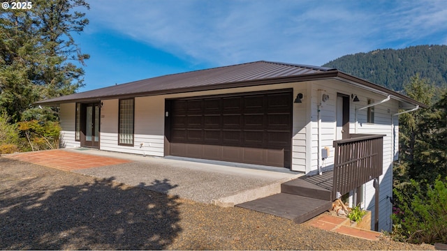 213 University Ave, Manzanita, OR 97130 - view of front of property with a mountain view and metal roof