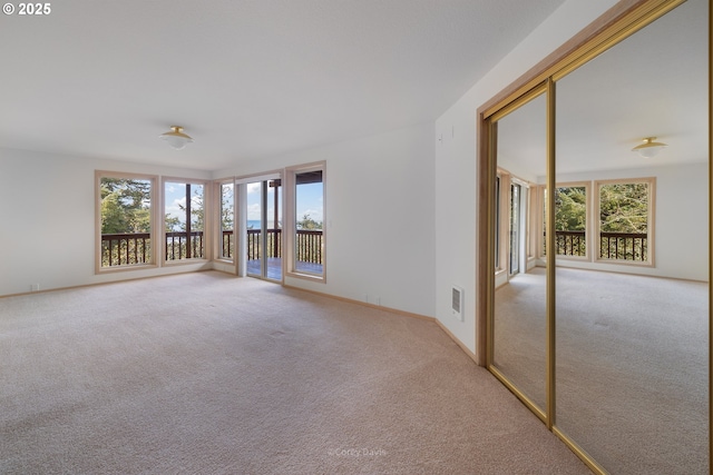 213 University Ave, Manzanita, OR 97130 - empty room featuring visible vents, baseboards, and light colored carpet