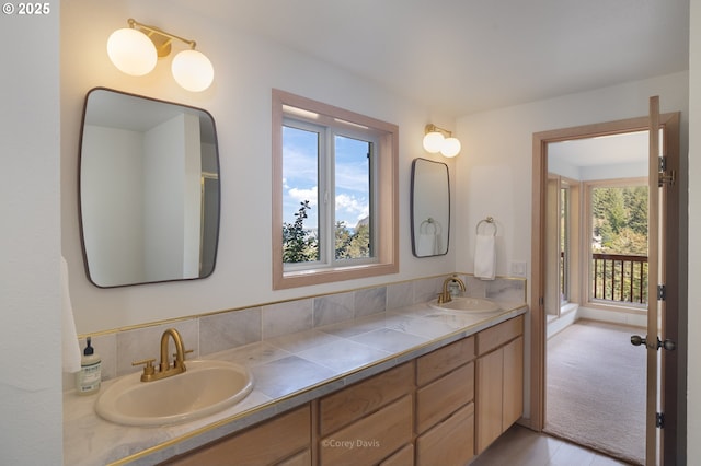 213 University Ave, Manzanita, OR 97130 - full bath featuring a sink, double vanity, and a healthy amount of sunlight
