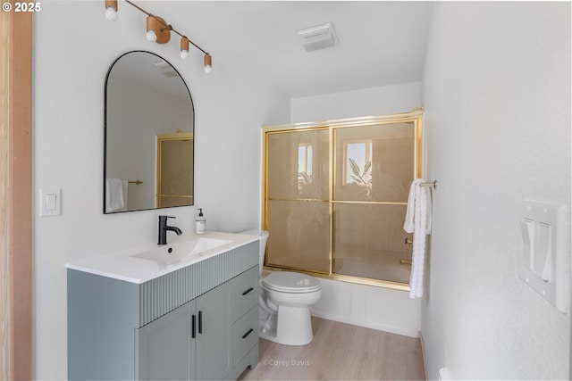 213 University Ave, Manzanita, OR 97130 - full bath with shower / bath combination with glass door, vanity, toilet, and wood finished floors
