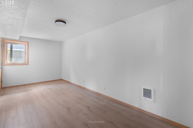 213 University Ave, Manzanita, OR 97130 - empty room with light wood-style floors, visible vents, a textured ceiling, and baseboards