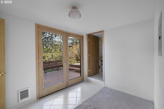 213 University Ave, Manzanita, OR 97130 - entryway featuring light tile patterned floors, french doors, visible vents, and heating unit