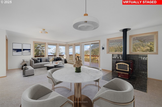 213 University Ave, Manzanita, OR 97130 - living room with a wood stove, baseboards, and carpet flooring