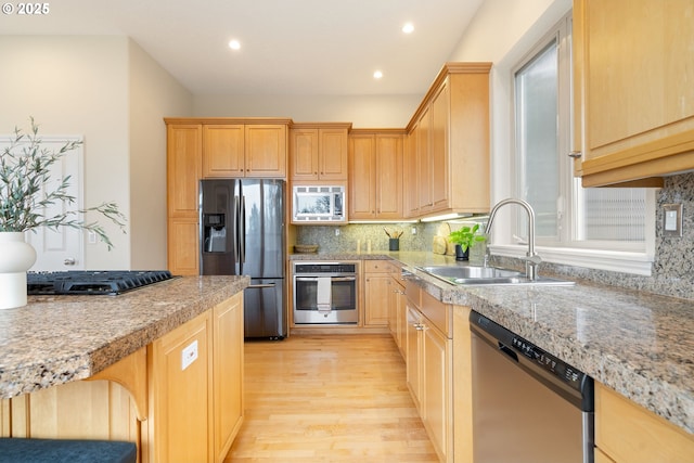 230 SW Florida St, Portland, OR 97219 - kitchen with appliances with stainless steel finishes, light wood-style floors, light countertops, backsplash, and recessed lighting