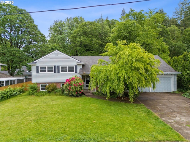 split level home featuring a front lawn, a garage, and a chimney
