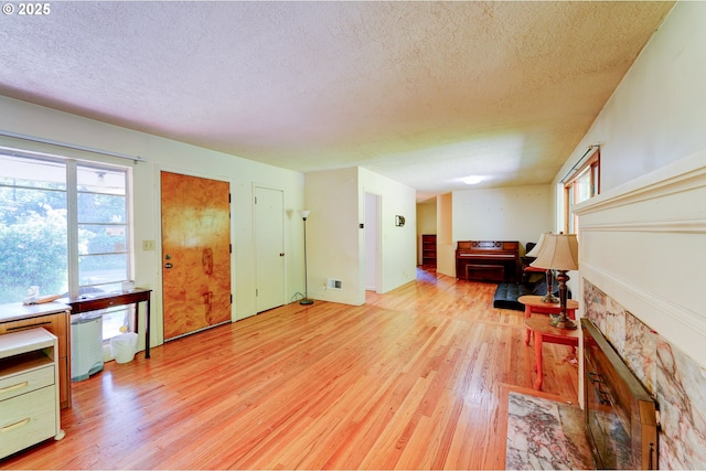 6620 SE Barbara Welch Rd, Portland, OR 97236 - living area with a textured ceiling and light wood-style floors