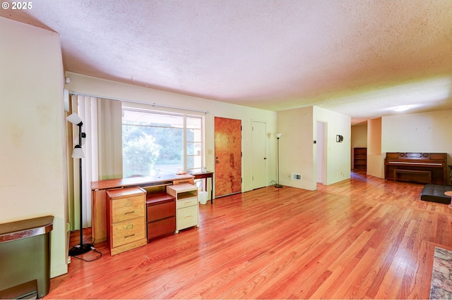 6620 SE Barbara Welch Rd, Portland, OR 97236 - living room featuring a textured ceiling and light wood-style flooring