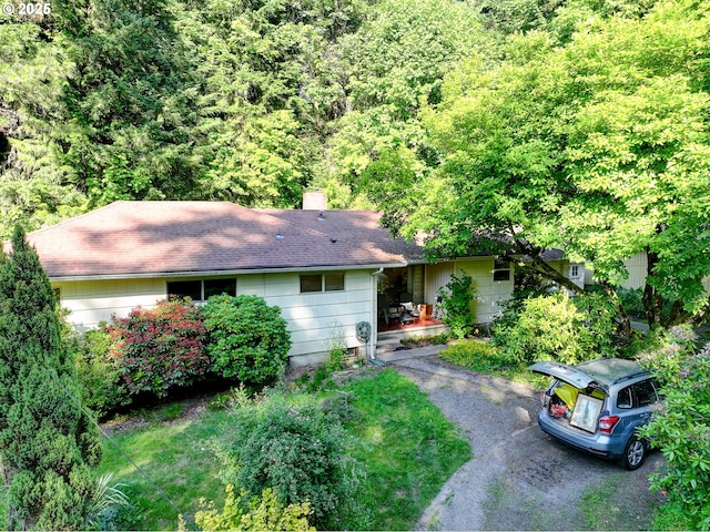 6620 SE Barbara Welch Rd, Portland, OR 97236 - view of front of home featuring a shingled roof, a view of trees, and a chimney