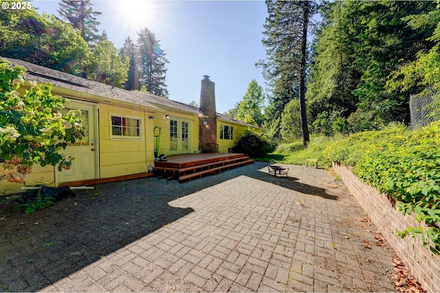 6620 SE Barbara Welch Rd, Portland, OR 97236 - view of patio with a fire pit, french doors, and a wooden deck