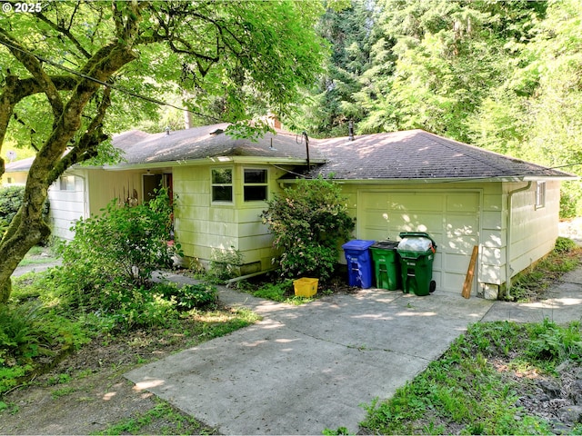6620 SE Barbara Welch Rd, Portland, OR 97236 - back of property with driveway, roof with shingles, and a garage