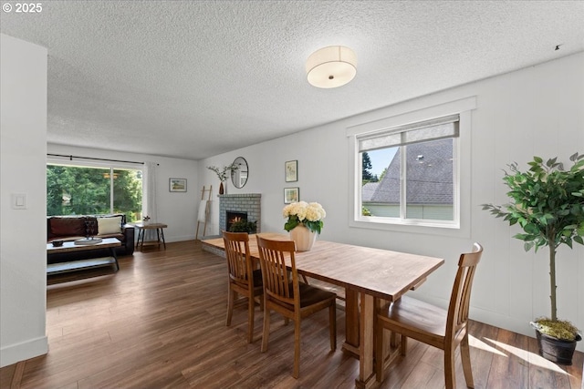1941 NE 143rd Ave, Portland, OR 97230 - dining area featuring wood finished floors, a fireplace, and a textured ceiling